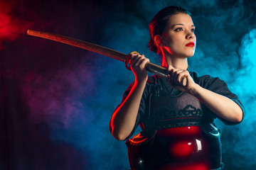 young caucasian woman love kendo fighting, hold bamboo sword in hands, practice fighting isolated...