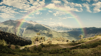 Beautiful Mountains in Clouds with rainbow