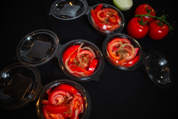 Ripe tomatoes on dark wooden background