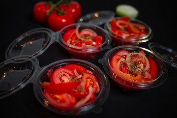 Ripe tomatoes on dark wooden background