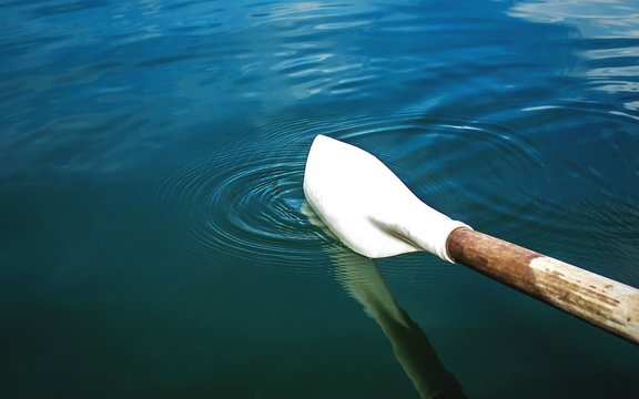 Cropped Image Of Oar On Rippled Lake