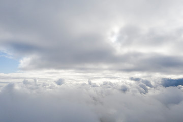 Obraz premium Aerial view white clouds in blue sky. View from drone. Aerial top view cloudscape. Texture of clouds. View from above. Sunrise or sunset over clouds. Panorama clouds