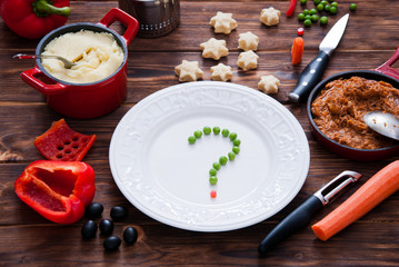 What to cook. Peas on a plate on a dark wooden background