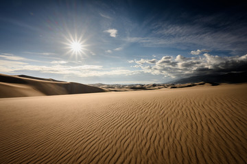 Fototapeta na wymiar Sun Burst Over Rippled Dune