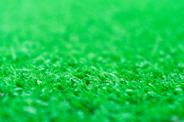 Fototapeta premium Artificial grass lawn texture. Artificial Turf Background. Greening with an artificial grass. Artificial turf laying background texture. Synthenic grass layer