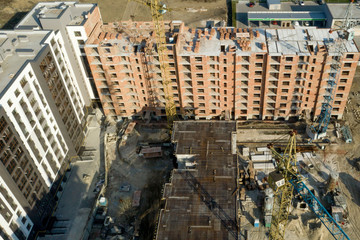 Construction and construction of high-rise buildings, the construction industry with working equipment and workers. View from above, from above. Background and texture