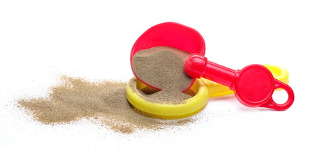 Plastic shovel, beach toy for kids in sand pile, isolated on white background