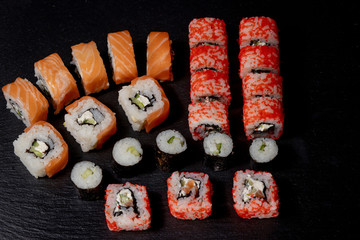Set of sushi roll on black slate background food fish philadelphia japanese salmon delicious sushi rice cucumber meal traditional wasabi fresh healthy gourmet raw cuisine