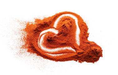 Red paprika powder pile in heart shape isolated on white background