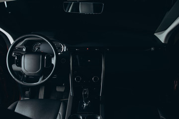 Toned in black Luxury car inside, automatic gear stick of a modern car. Dark leather interior