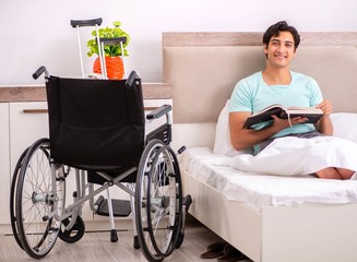 Young handsome disabled man recovering at home