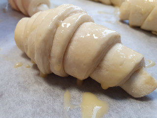 Prepare croissants for bake in oven. White background. Top view, background, Rustic. Bakery concept