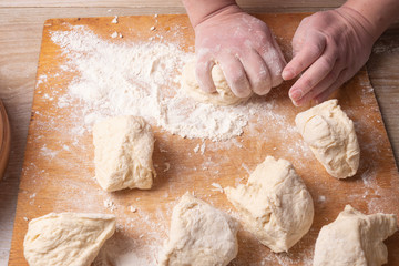 Female hands mixing dough in the home kitchen.