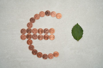 Euro sign made by 1 euro coin on gray background