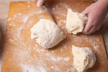 Female hands mixing dough in the home kitchen.