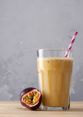 Fruit protein shake on a wooden table. Fresh milkshake with passion fruit. A glass of protein shake.