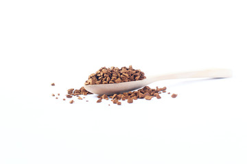 Freeze dried coffee., Wooden spoon with granulated Instant Coffee., close-up on white background.