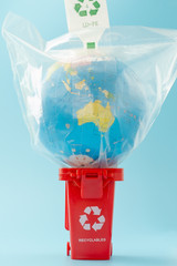 The red recycling bin on blue background