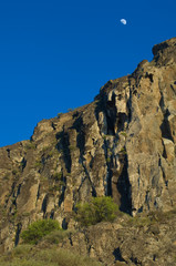 Moon over a cliff in the Roque Nublo Natural Monument. The Nublo Rural Park. Tejeda. Gran Canaria. Canary Islands. Spain.