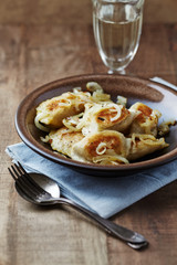 Dumplings with potato and cottage cheese stuffing (pierogi). Traditional Polish Christmas Dinner. Rustic wooden background.