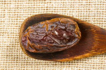 Big luxury dried date fruit on a linen napkin, kurma ramadan kareem concept, close up.