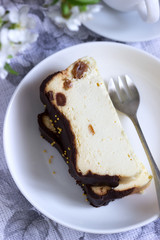 Lviv cheesecake, a traditional Ukrainian dessert with raisins, coated with chocolate icing.