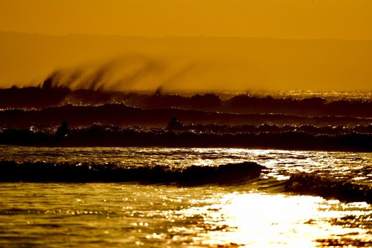 Sunset Obver Windy Surf With Dramatic Spray In North Devon