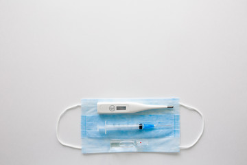 Fototapeta premium medical mask on a black background.face mask. mask for diseases. Thermometer and medication. the image of a single person. Medical breathing bandage on the face. The concept of quarantine coronavirus.