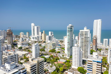 Fototapeta na wymiar Aerial view of a skyline of white residential skyscrapers in Cartagena's prestigious Bocagrande district.