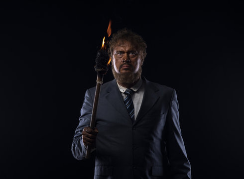 businessman with a torch at night