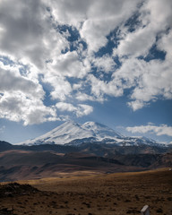 unt Elbrus in the clouds with an autumn landscape