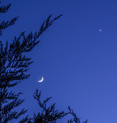 Two sides of the Moon on the blue sky