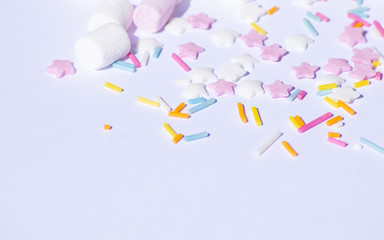 Sugar colorful sprinkles, stars and marshmallows, baking decorations in multicolor, bright picture, home made bakery White background with copy text space