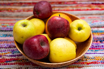 colorfull apples in a wooden plate