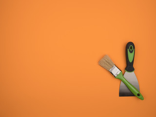 Green brush and spatula on an orange background.
