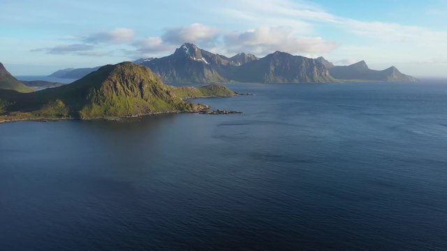 aerial view. flight over the sea,view on the Flakstadoya from Haukland beach and Mannen peak. Camera move left to right .Lofoten Islands,Norway