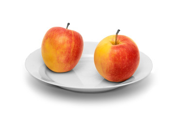 Two apples on white plate and  white background