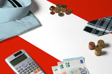 Austria flag on minimal money concept table. Coins and financial objects on flag surface. National economy theme.