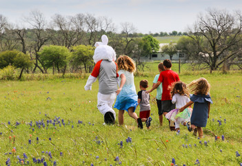 Children Chasing The Easter Bunny Through Blue Bonnets, Washington County, Texas, USA