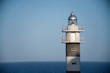 Fototapeta na wymiar Lighthouse an seagull in the port of the Spanish city of Aguilas