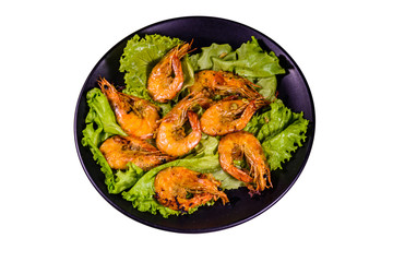 Plate with grilled shrimps and lettuce leaves isolated on a white background