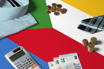 Comoros flag on minimal money concept table. Coins and financial objects on flag surface. National economy theme.