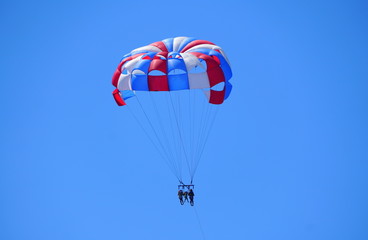 A distance view of parasailing excursion on a bright sunny day near near Madeira Beach, Florida, U.S.A
