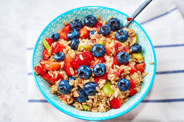 oatmeal with strawberries, blueberries, in a colorful bowl
