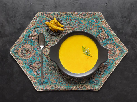 Healthy Curcuma Cream Soup On Black Background