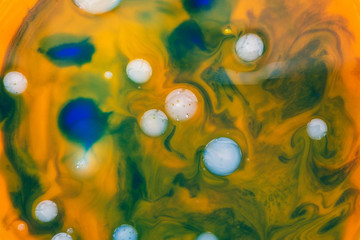 Colorful texture of mixed colors. Waves of orange and blue with oily white bubbles. Abstract...