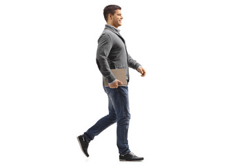 Man holding a book and walking