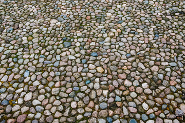 Puzzle of the colored stones on the ground. Pattern