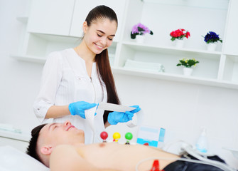 Electrocardiogram, ECG in hand. Clinic of Cardiology heart rate and pulse test closeup. Cardiogram...