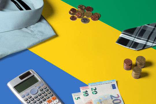 Gabon flag on minimal money concept table. Coins and financial objects on flag surface. National economy theme. - Powered by Adobe
